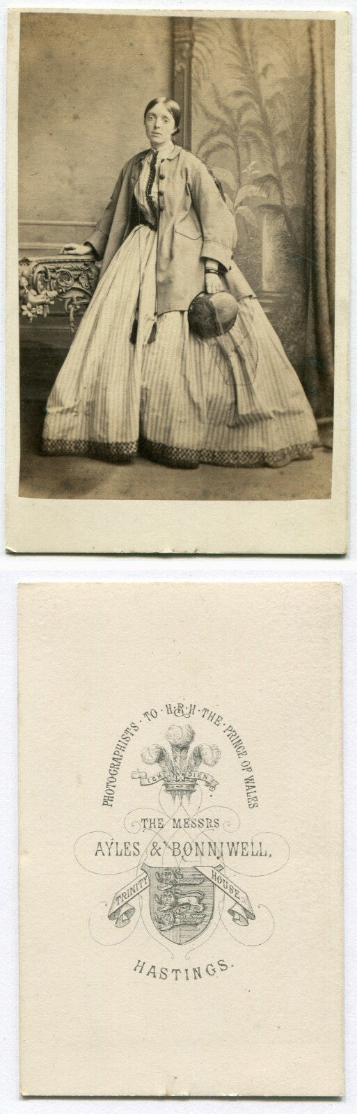 SAD EYED WOMAN POSED IN OVERCOAT HOLDING HAT. CDV. HASTINGS, ENGLAND.