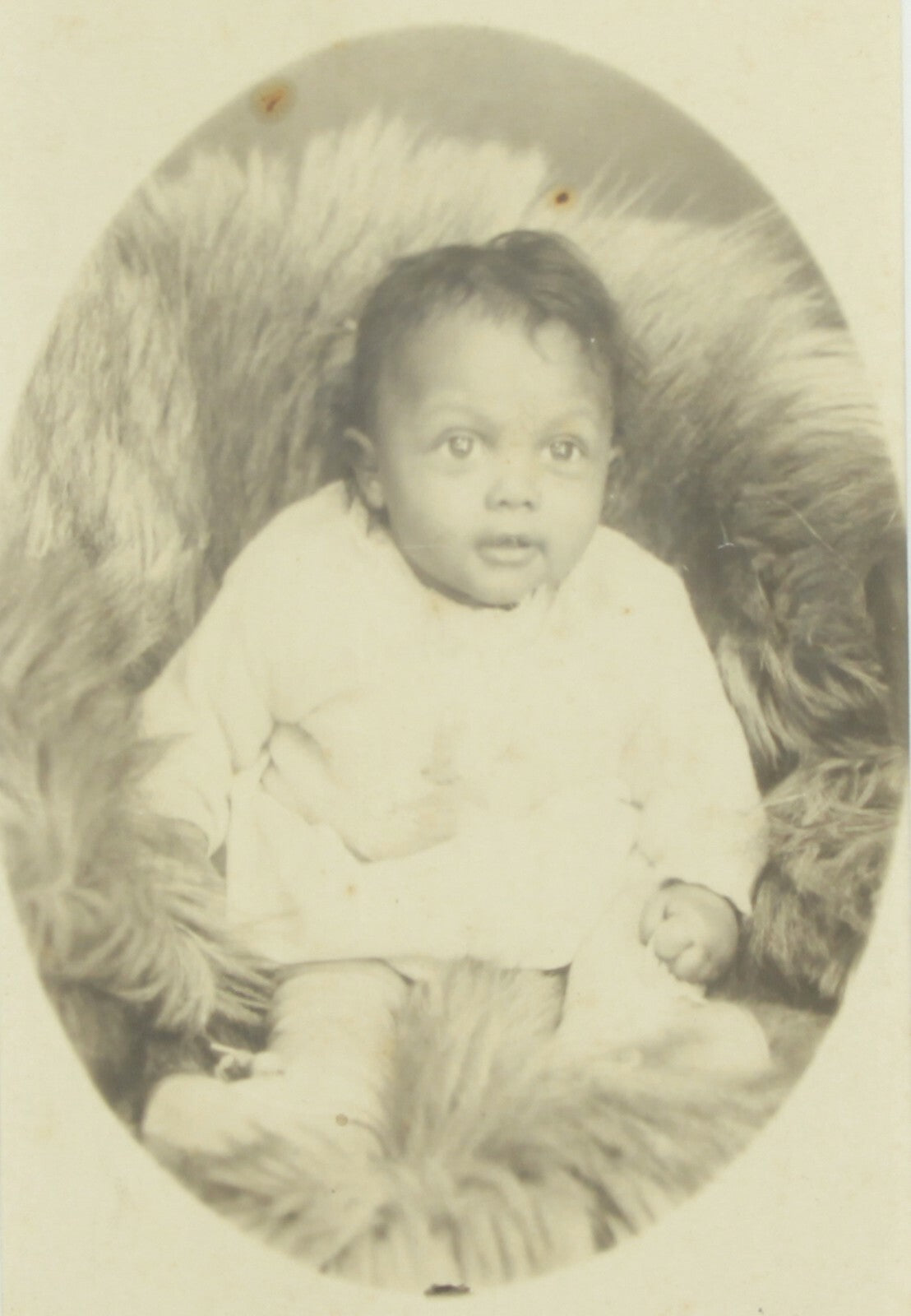 AFRICAN AMERICAN BABY POSED ON FUR BLANKET. CABINET CARD IN 5X7 FRAME.