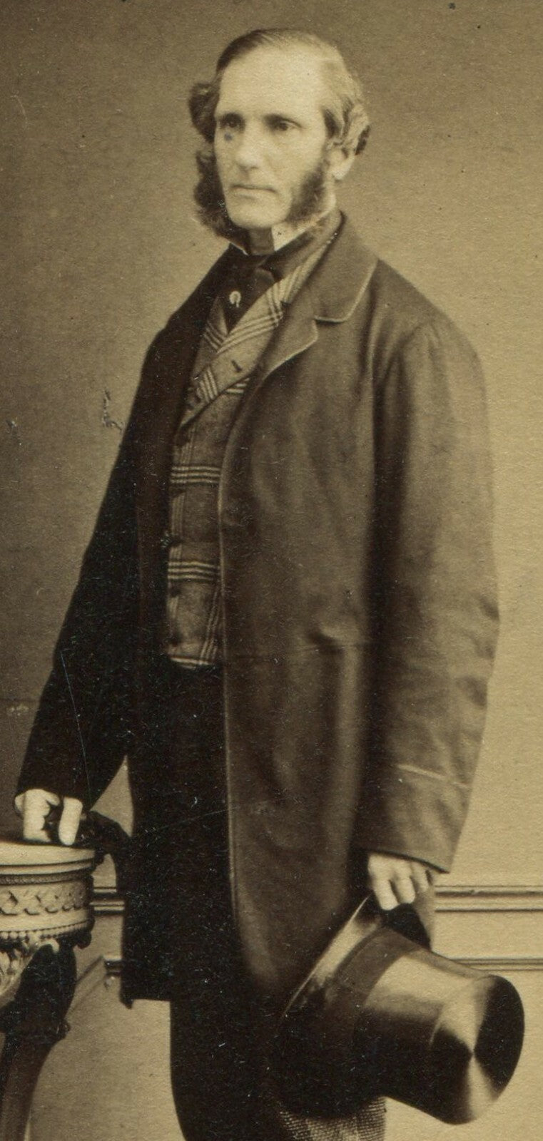 MAN W/MUTTON CHOP FACIAL HAIR, STANDING POSE HOLDING TOP HAT. CDV. LONDON.