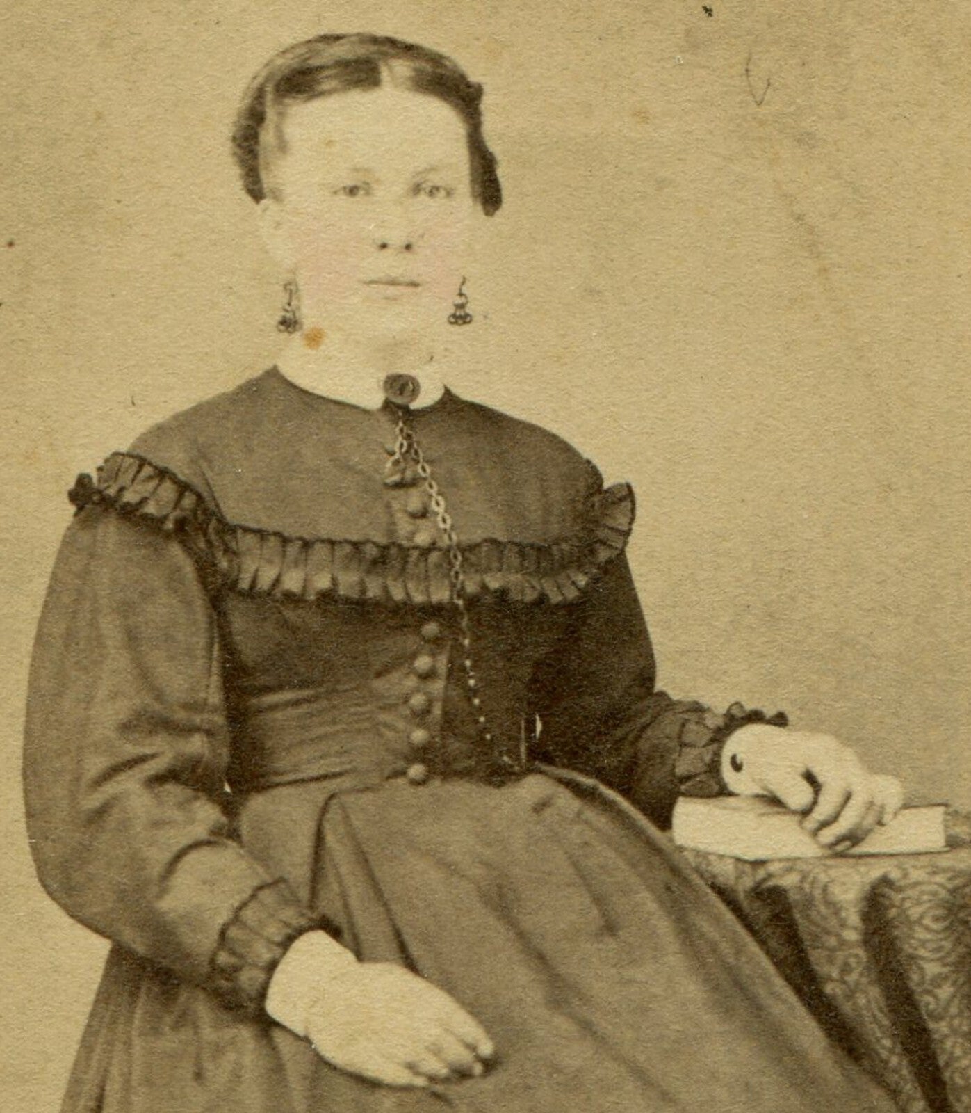 WOMAN, PLEATED DRESS SEATED AT TABLE W/BOOK. TINTED CDV. PILLOW, PA.