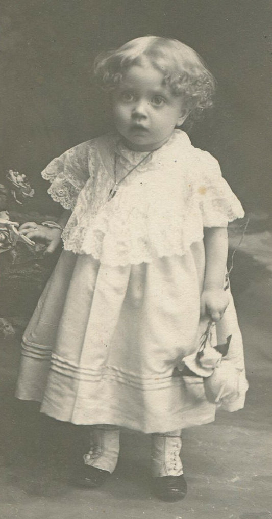 TODDLER POSED HOLDING A FLOWER. TRULY SWEET PHOTO. TONED SILVER PRINT.