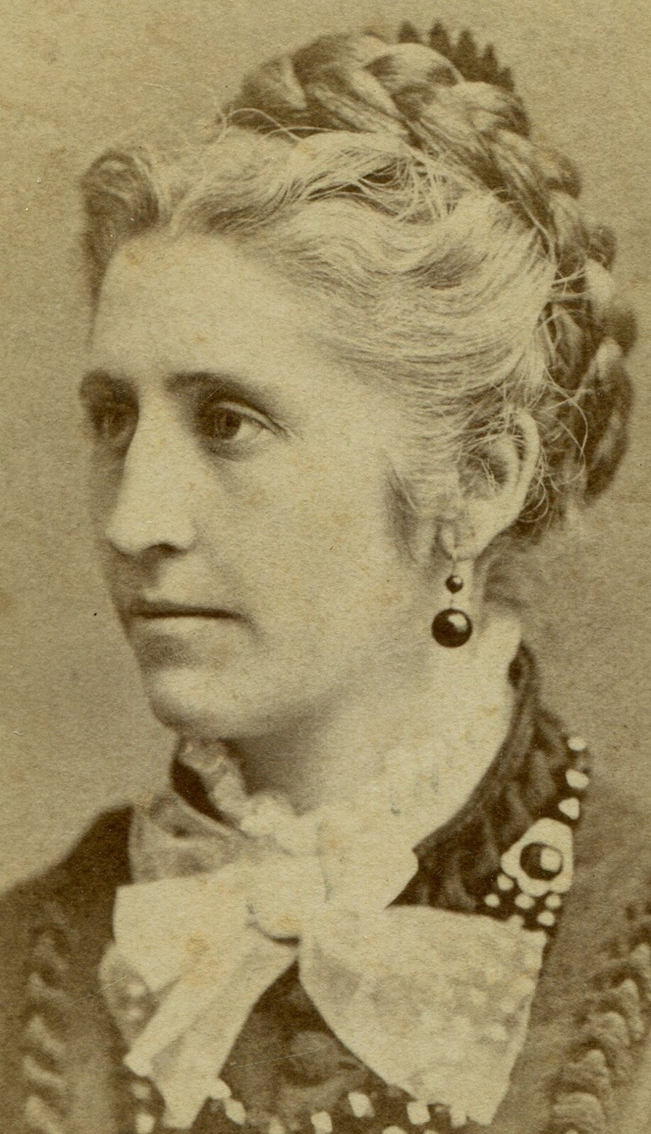WOMAN W/FRENCH BRAID, BIG BEADED NECKLACE AND LACE BOW TIE. CDV. ROCHESTER,N.Y.