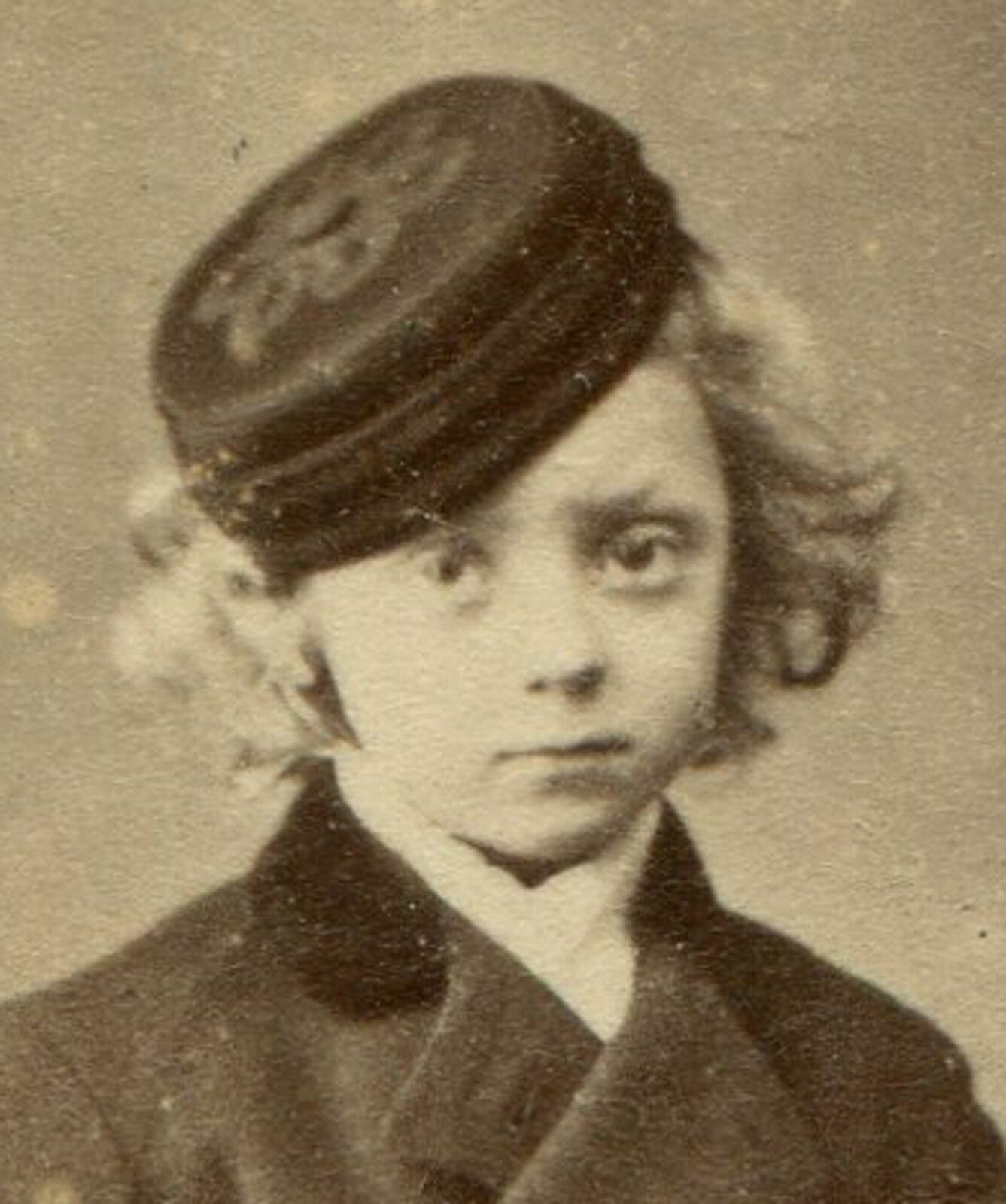 YOUNG BOY WITH WAVY HAIR, HIGH BOOTS AND WOOL HAT. CDV, DUBLIN, IRELAND.