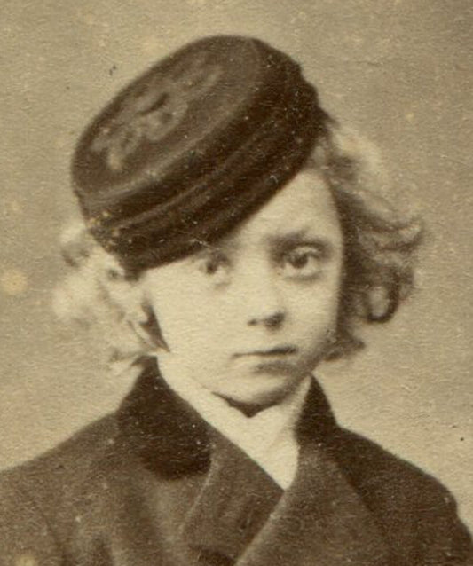 YOUNG BOY WITH WAVY HAIR, HIGH BOOTS AND WOOL HAT. CDV, DUBLIN, IRELAND.