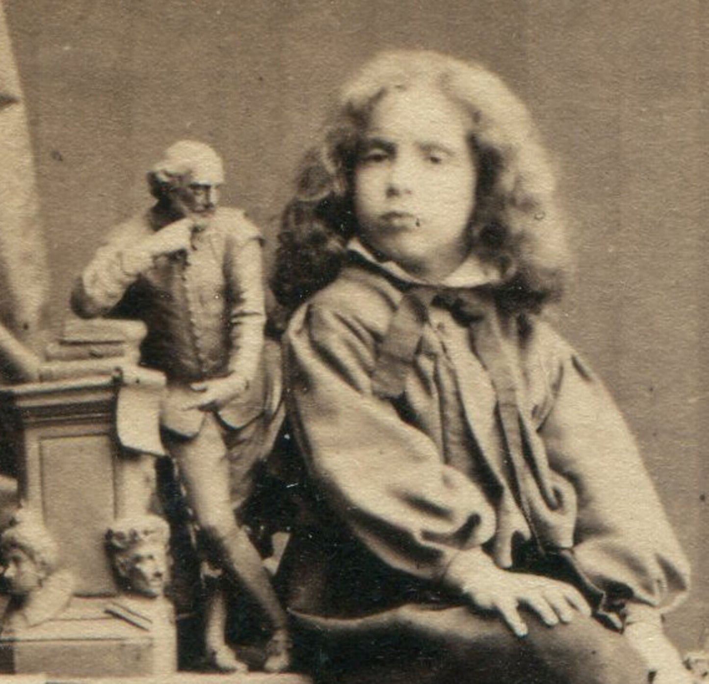 CHILD POSED WITH SMALL STATUE. WHIMSICAL STUDIO SETTING. CDV. LONDON.