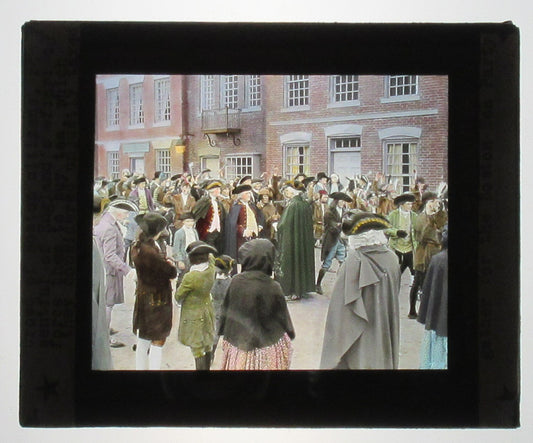 ACTORS PORTRAY BOSTON CROWD, PROTEST TEA TAX. HAND COLORED PHOTO ON GLASS.