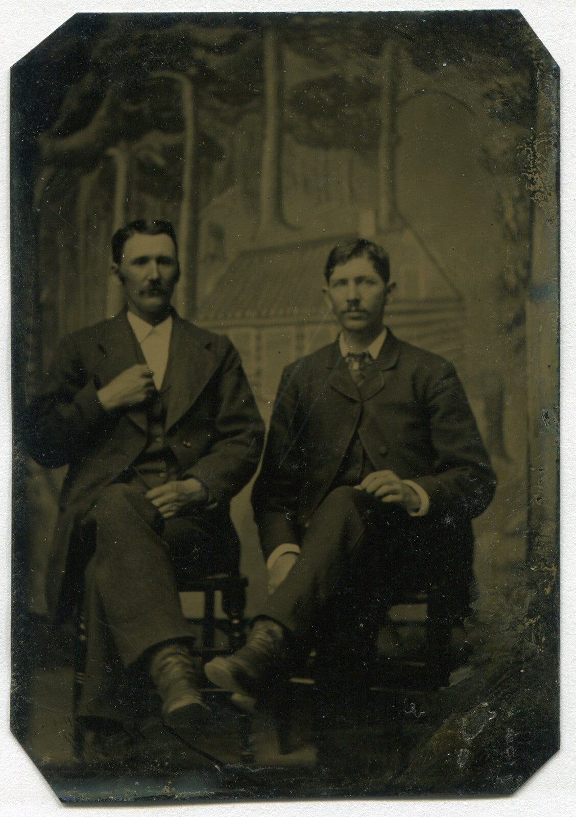 TWO MEN, SEATED. PAINTED BACKGROUND TINTYPE.