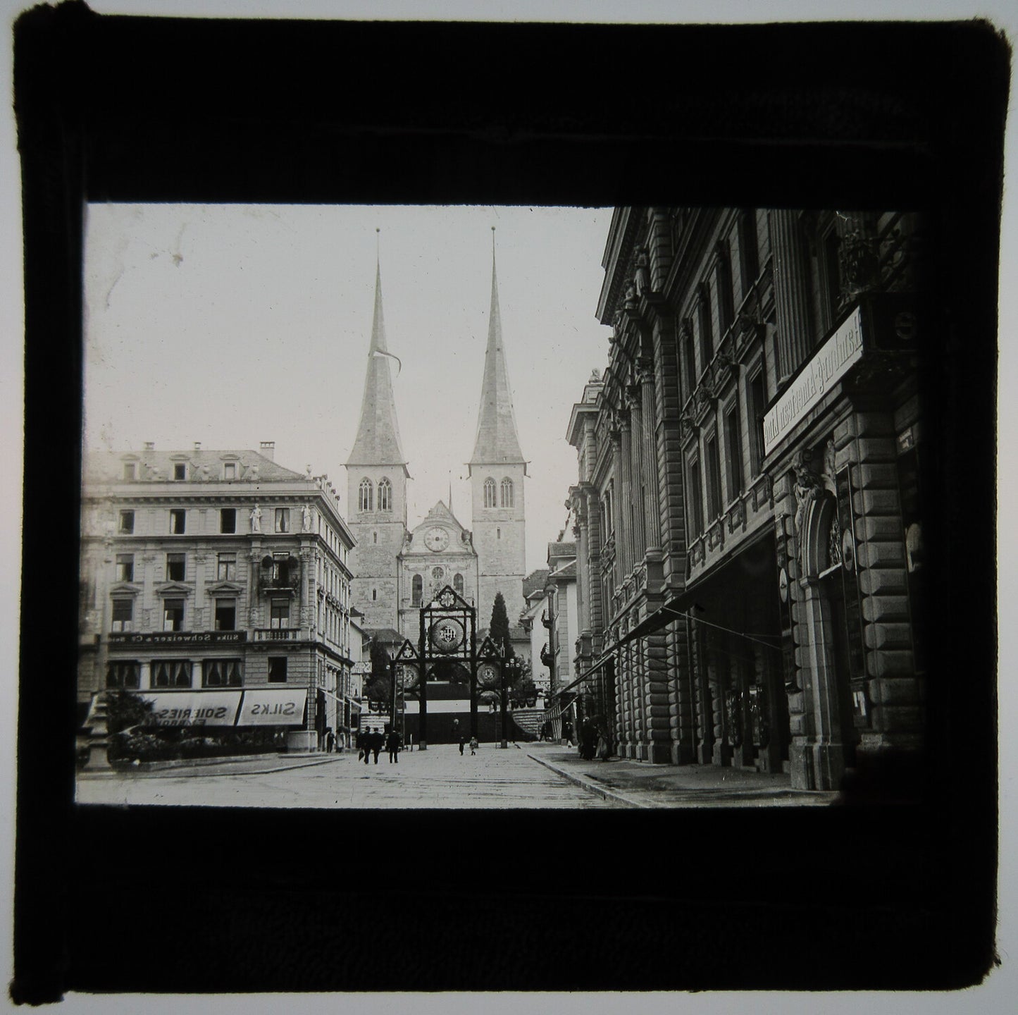 URBAN STREET W/CHURCH AT END WITH TALL SPIRES. LANTERN SLIDE.