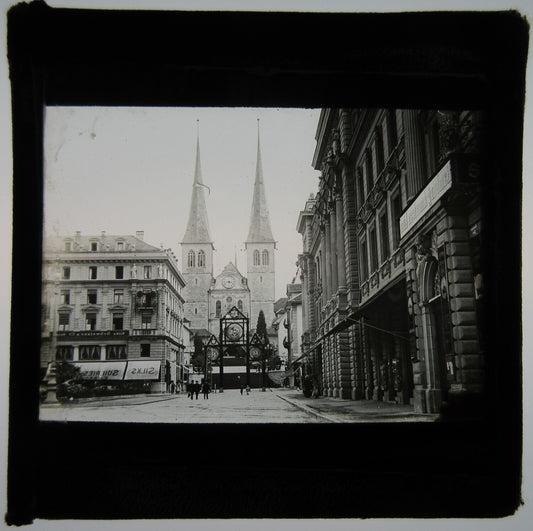 URBAN STREET W/CHURCH AT END WITH TALL SPIRES. LANTERN SLIDE.
