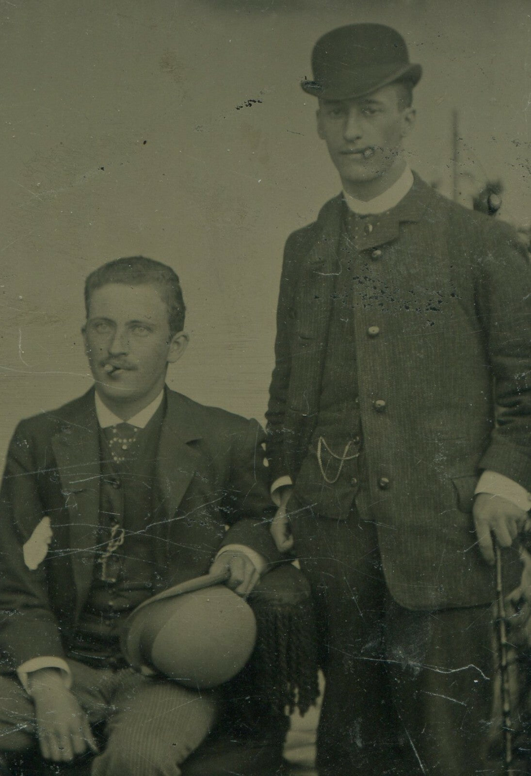 TWO MEN W/CIGARS, BOWLER HATS AND CANE. TINTYPE.