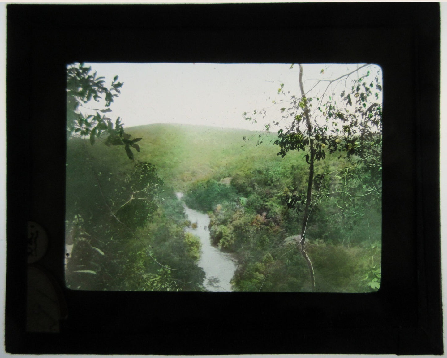 Vintage hand-colored photo on glass: River and Hills - Tinted lantern slide, cracked safety glass, approx 3.25 x 3.5 in