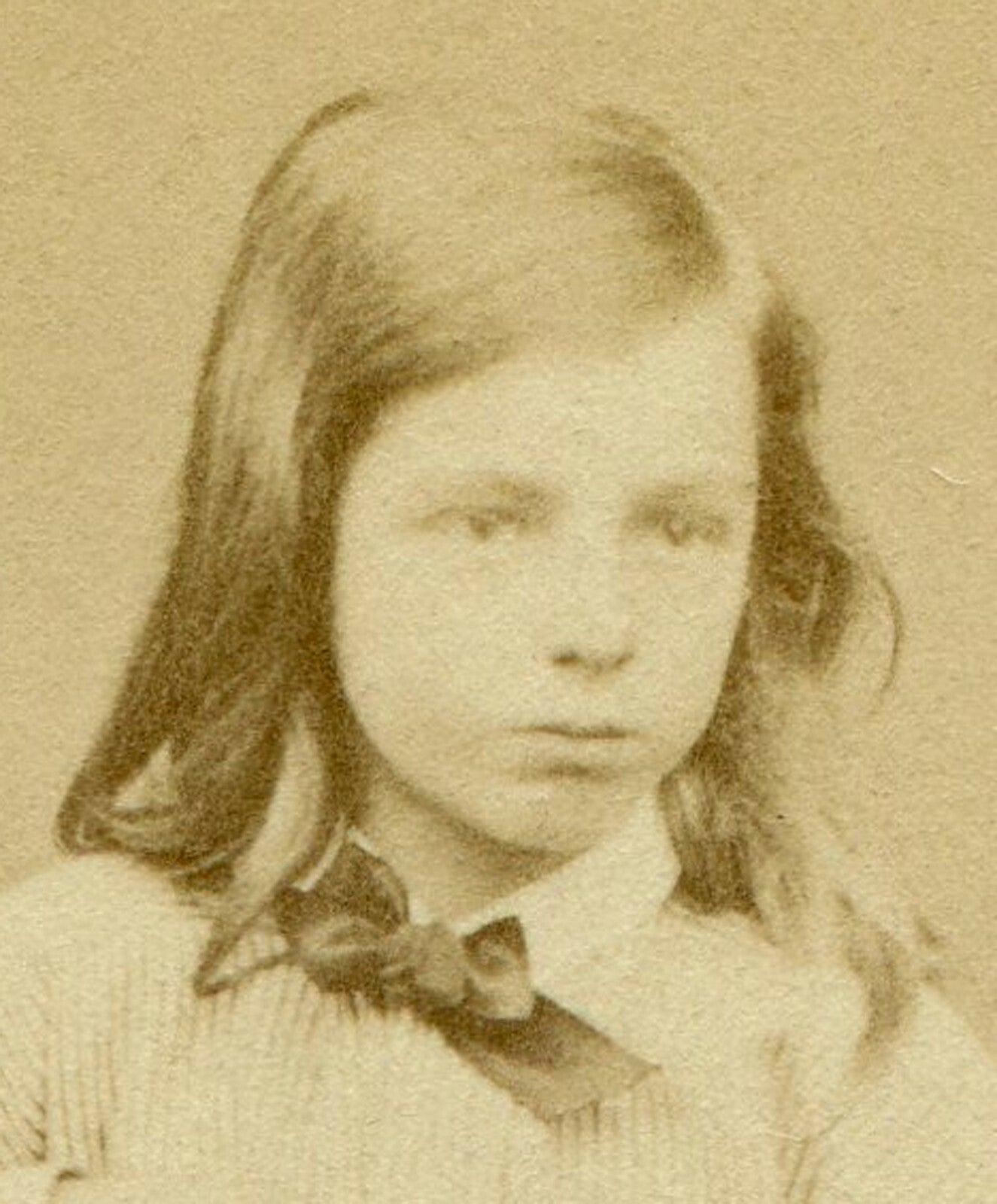 LONG HAIRED CHILD POSED ON CHAIR, HAND ON FOOT. CDV. IPSWICH, ENGLAND.
