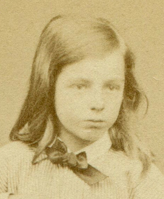 LONG HAIRED CHILD POSED ON CHAIR, HAND ON FOOT. CDV. IPSWICH, ENGLAND.