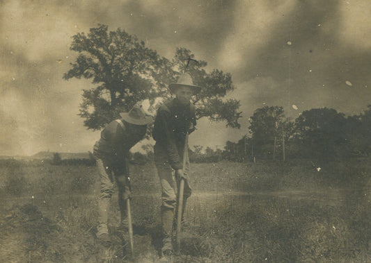 TWO MEN IN U.S. MILITARY UNIFORM DIGGING IN A FIELD. 3.75X4.75 TONED B&W.