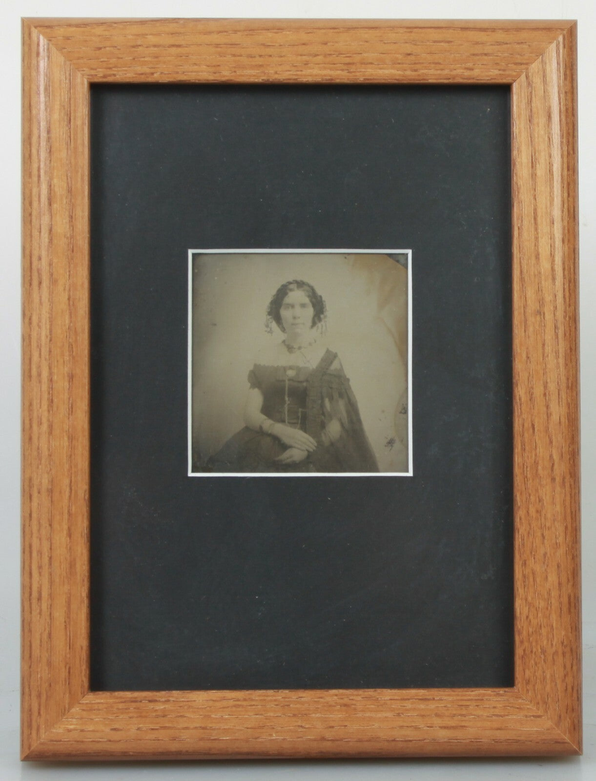 BEAUTIFUL, HAUNTING AMBROTYPE OF A WOMAN. 5X7 FRAME WITH ARCHIVAL MATTING.