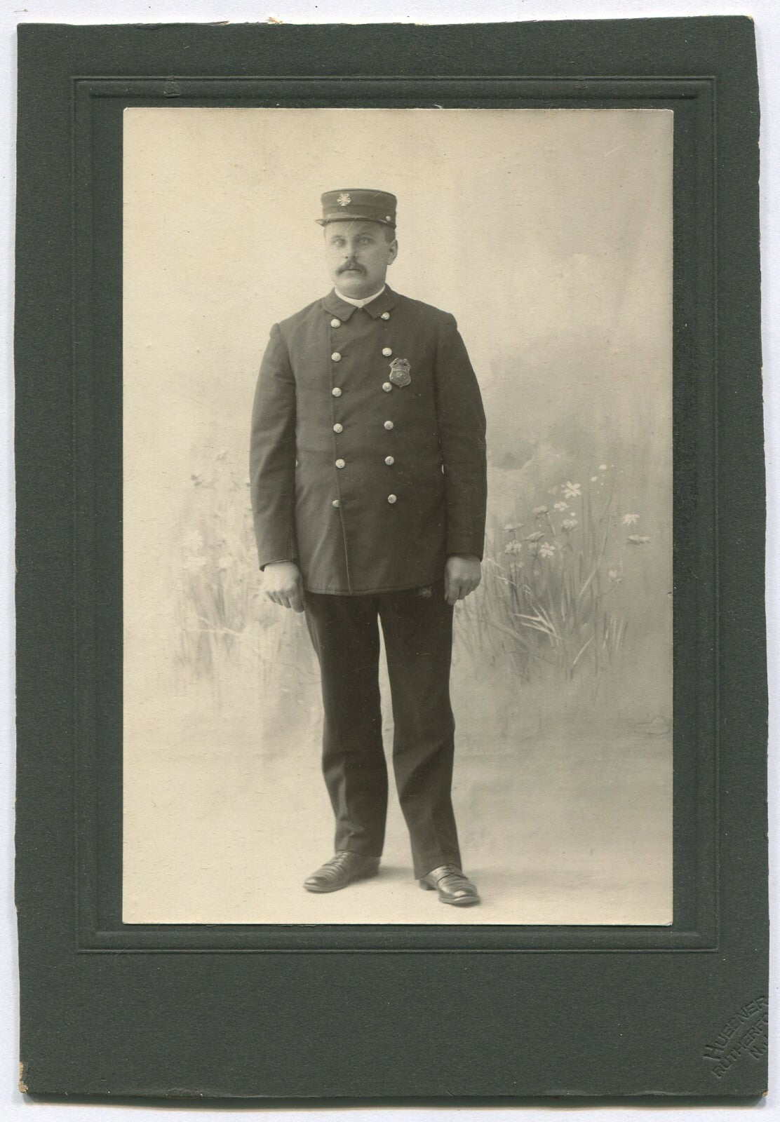 FIREMAN IN UNIFORM. B&W PHOTO W/PAINTED BACKGROUND.