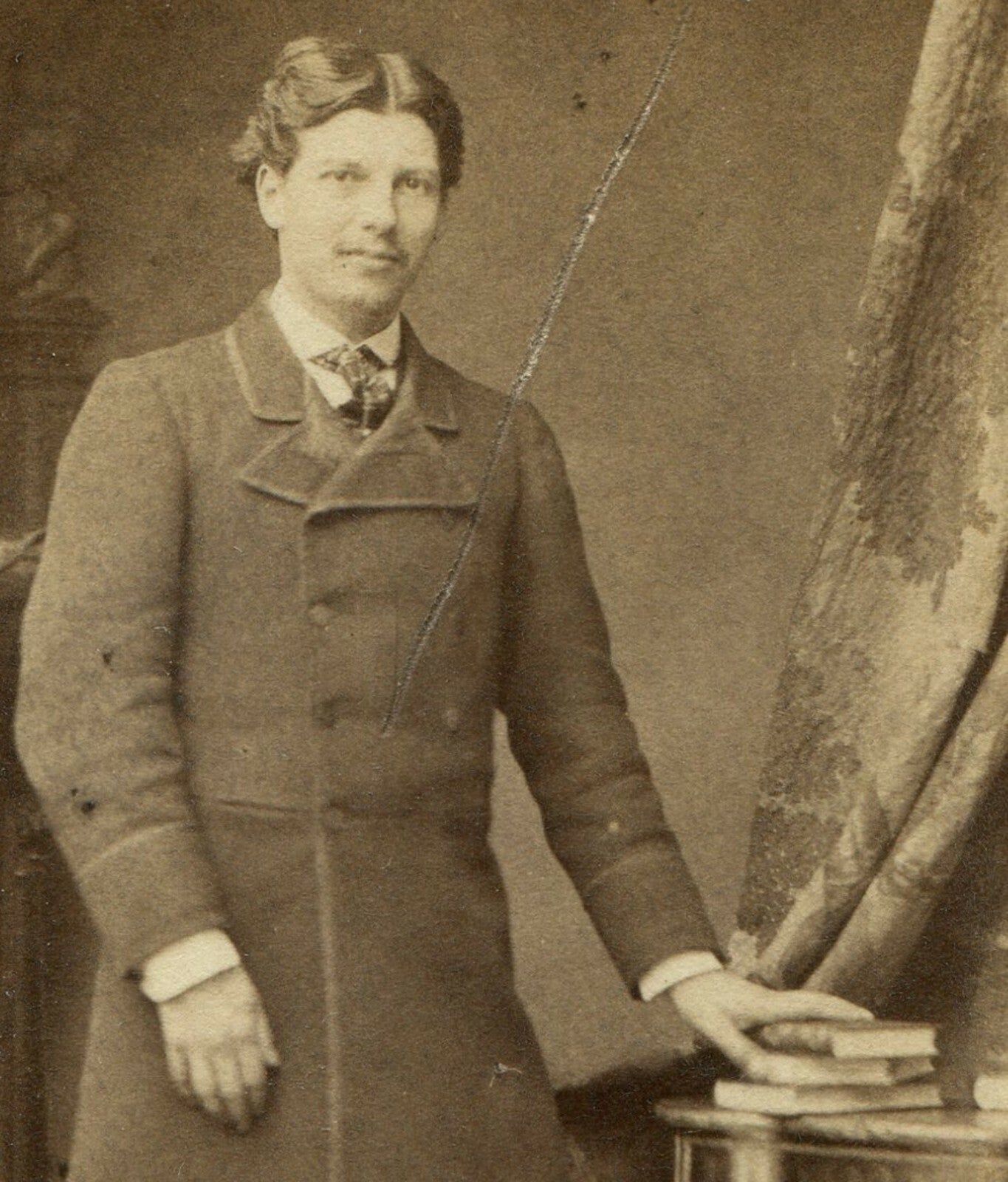 MAN IN LONG COAT POSED AT TABLE W/BOOKS. CDV. PARIS, FRANCE.