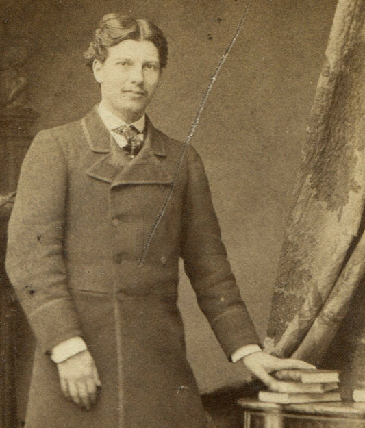 MAN IN LONG COAT POSED AT TABLE W/BOOKS. CDV. PARIS, FRANCE.