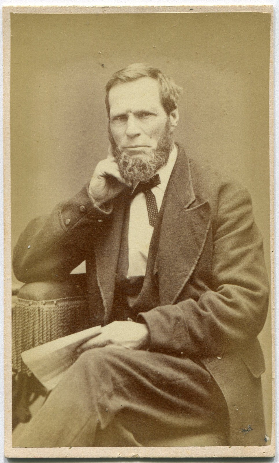 BEARDED, GRIMACING MAN, SEATED, HOLDING BOOK. CDV. ELMIRA, N.Y.