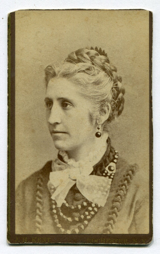 WOMAN W/FRENCH BRAID, BIG BEADED NECKLACE AND LACE BOW TIE. CDV. ROCHESTER,N.Y.
