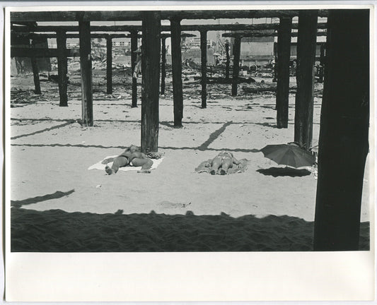 YOUNG COUPLE SUNBATHING, PIER SHADOWS. B&W 8X10.1970s B&W 8x10
