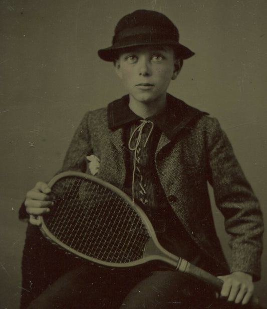 YOUNG BOY IN HAT, POSED W/TENNIS RACKET. TINTED TINTYPE.