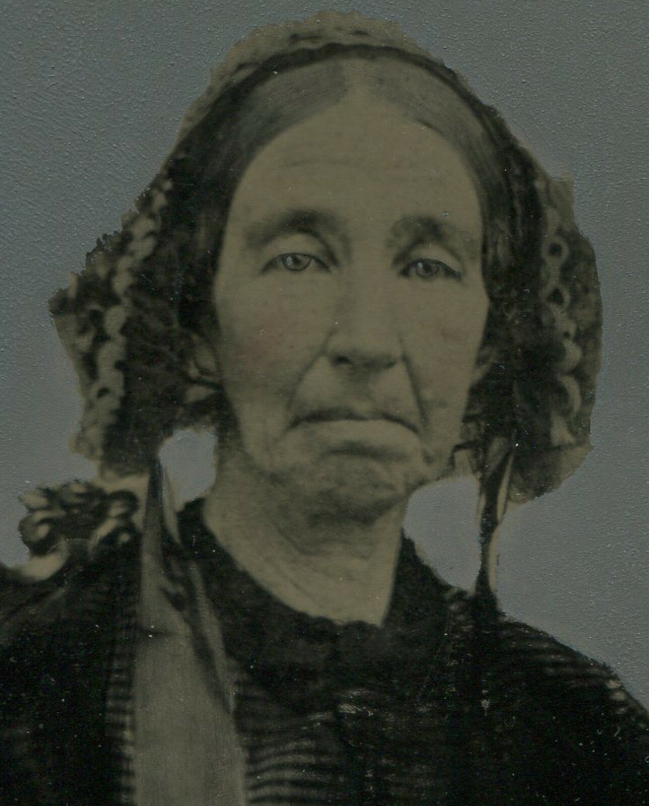 FOLK ART TINTYPE. PAINTED/TINTED PHOTO OF WOMAN IN BONNET. 5 X 7 IN.