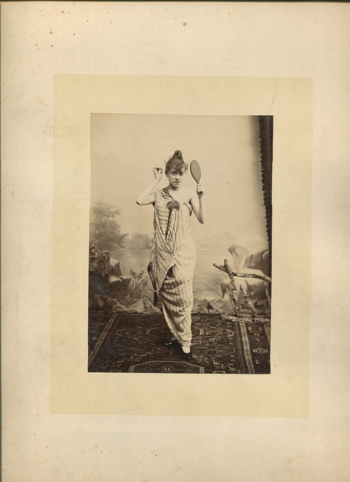 ACTRESS POSED LOOKING INTO HAND MIRROR. 6.5X4.5 ALBUMEN ON 12X9.5 CARD.