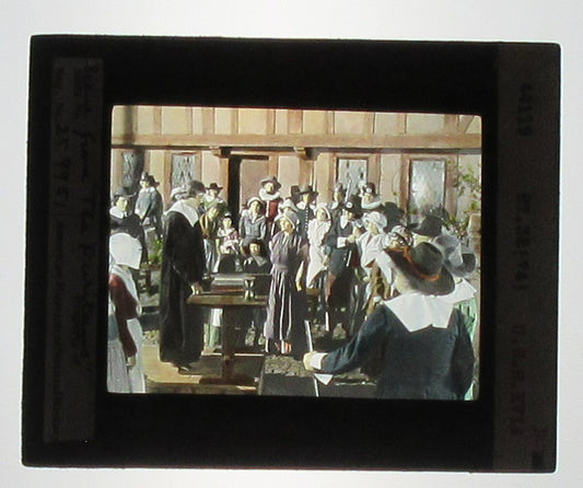 ACTORS PORTRAY JOHN COTTON/PURITANS. HAND COLORED PHOTO ON GLASS.