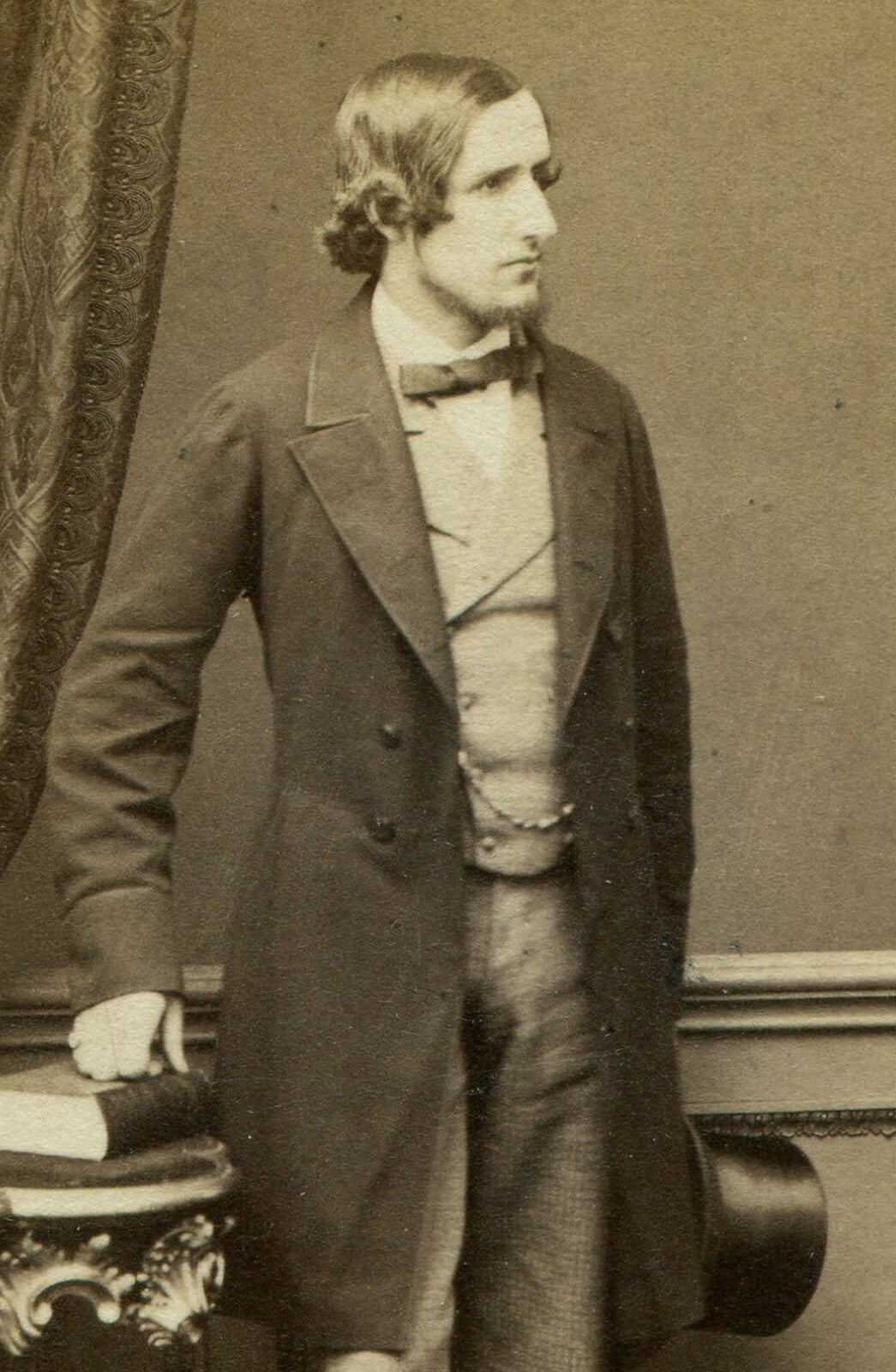 LIONEL TOLLEMACHE POSED HOLDING TOP HAT, LEANING ON TABLE W/BOOKS. CDV. LONDON.
