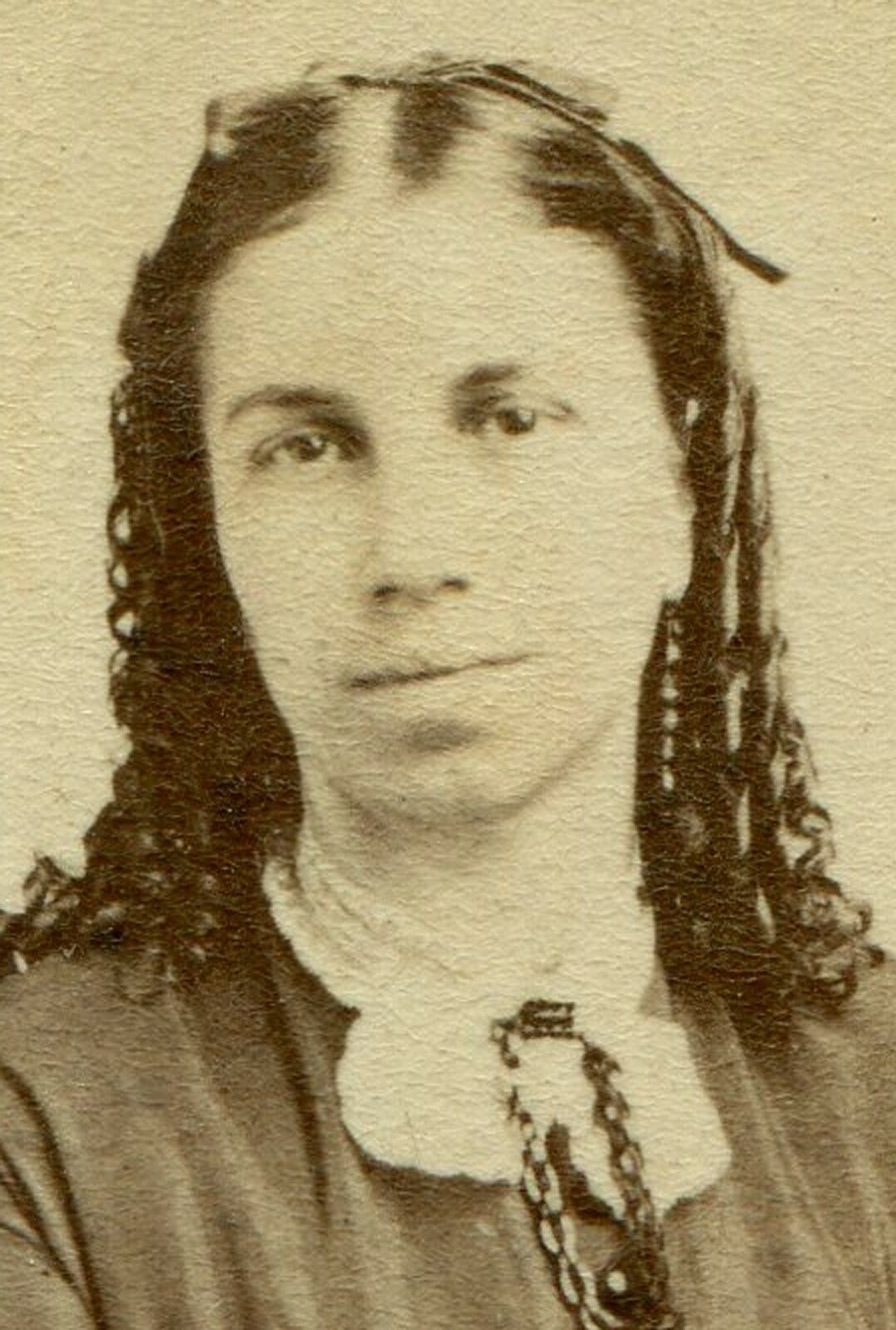 WOMAN, LONG RINGLET CURLS, SEATED AT POSING CHAIR. CDV.