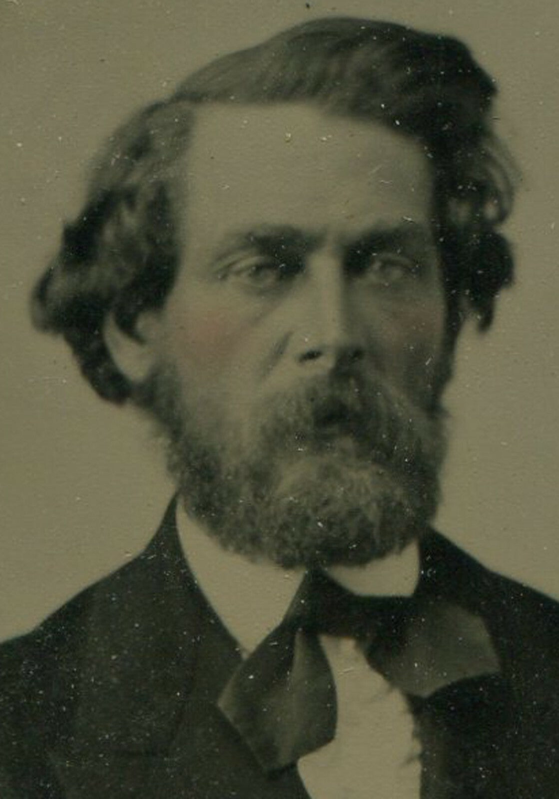 VERY HANDSOME MAN WITH WILD HAIR. TINTED TINTYPE IN PERIOD PAPER MAT.