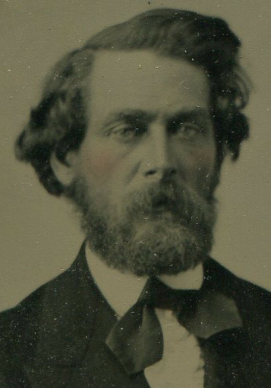 VERY HANDSOME MAN WITH WILD HAIR. TINTED TINTYPE IN PERIOD PAPER MAT.