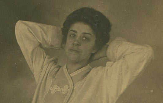 WOMAN, RELAXED POSE, WEARING SILK PAJAMAS. PHOTO POSTCARD.