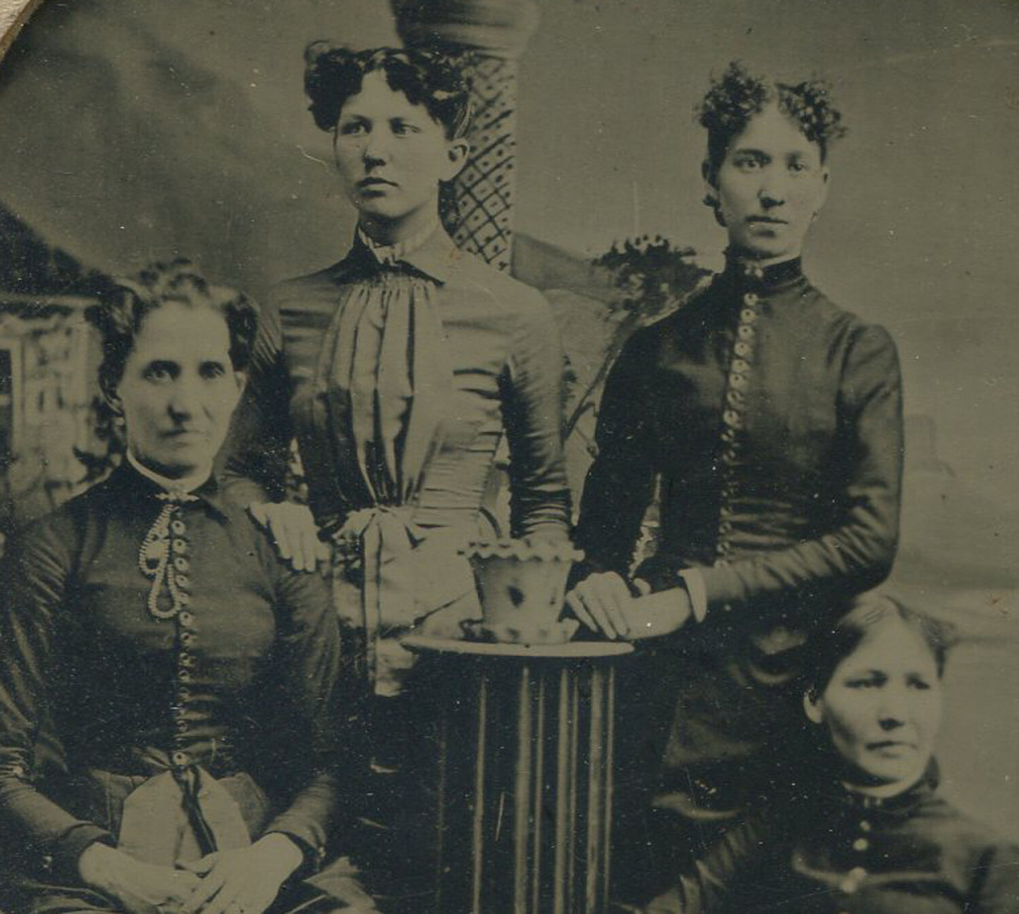 FOUR WOMEN, TWINS W/UNFORTUNATE HAIRSTYLE. TINTYPE IN PAPER MAT, 6X4 IN.