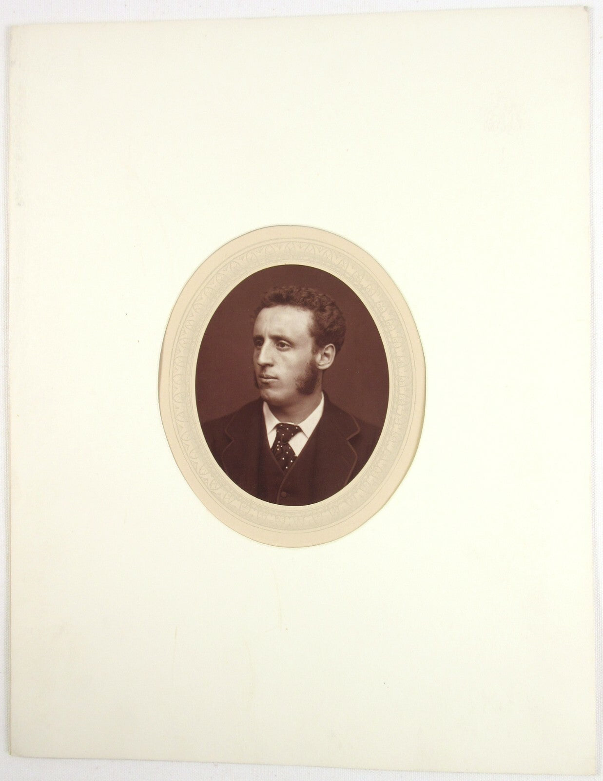 WALTER W. OULESS. 4.5X3.5 OVAL WOODBURYTYPE ON 11.25X8.5 INCH PAGE IN 11X14 MAT.