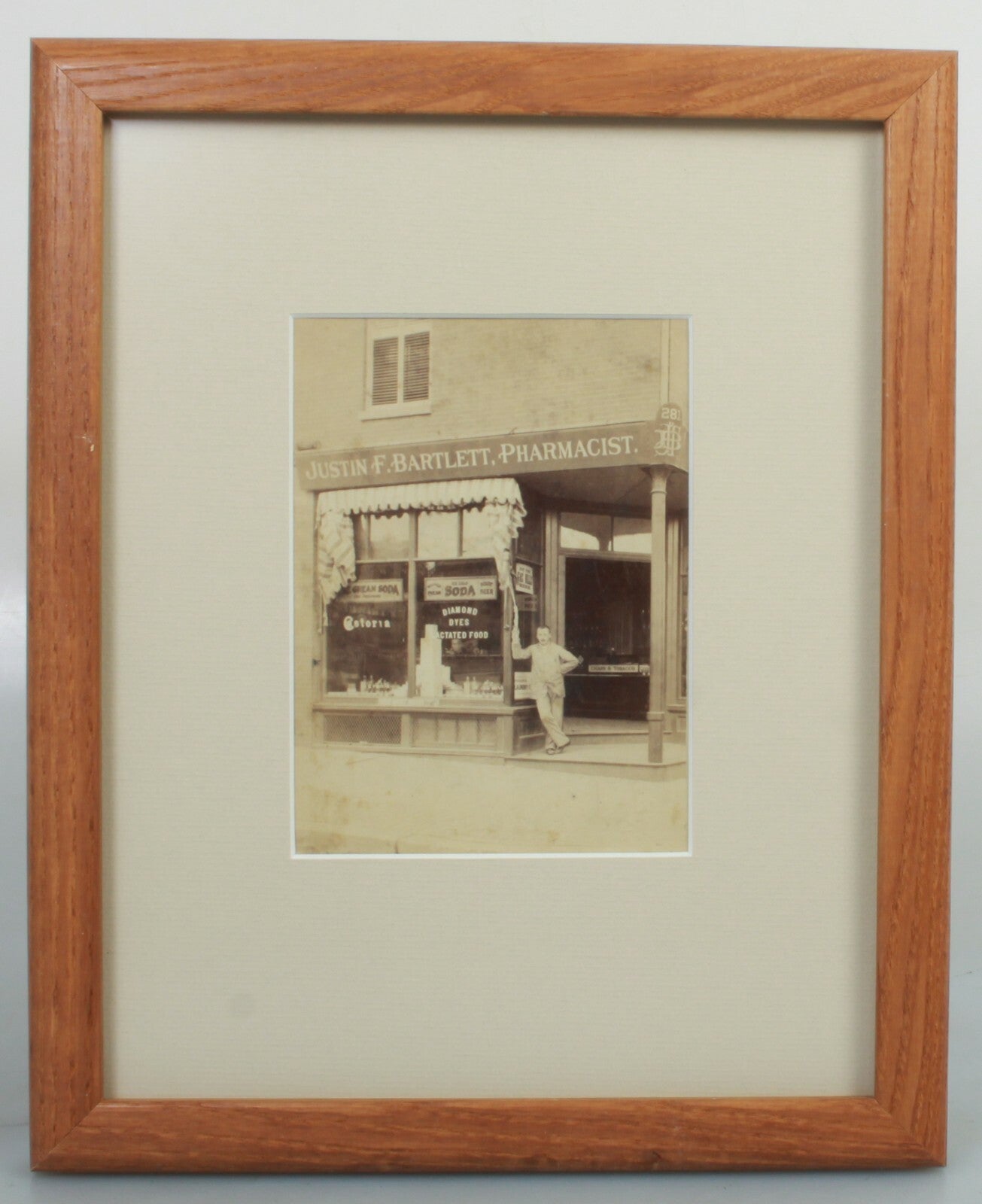 JUSTIN F. BARTLETT  PHARMACIST STORE CAB CARD IN 8X10 FRAME.