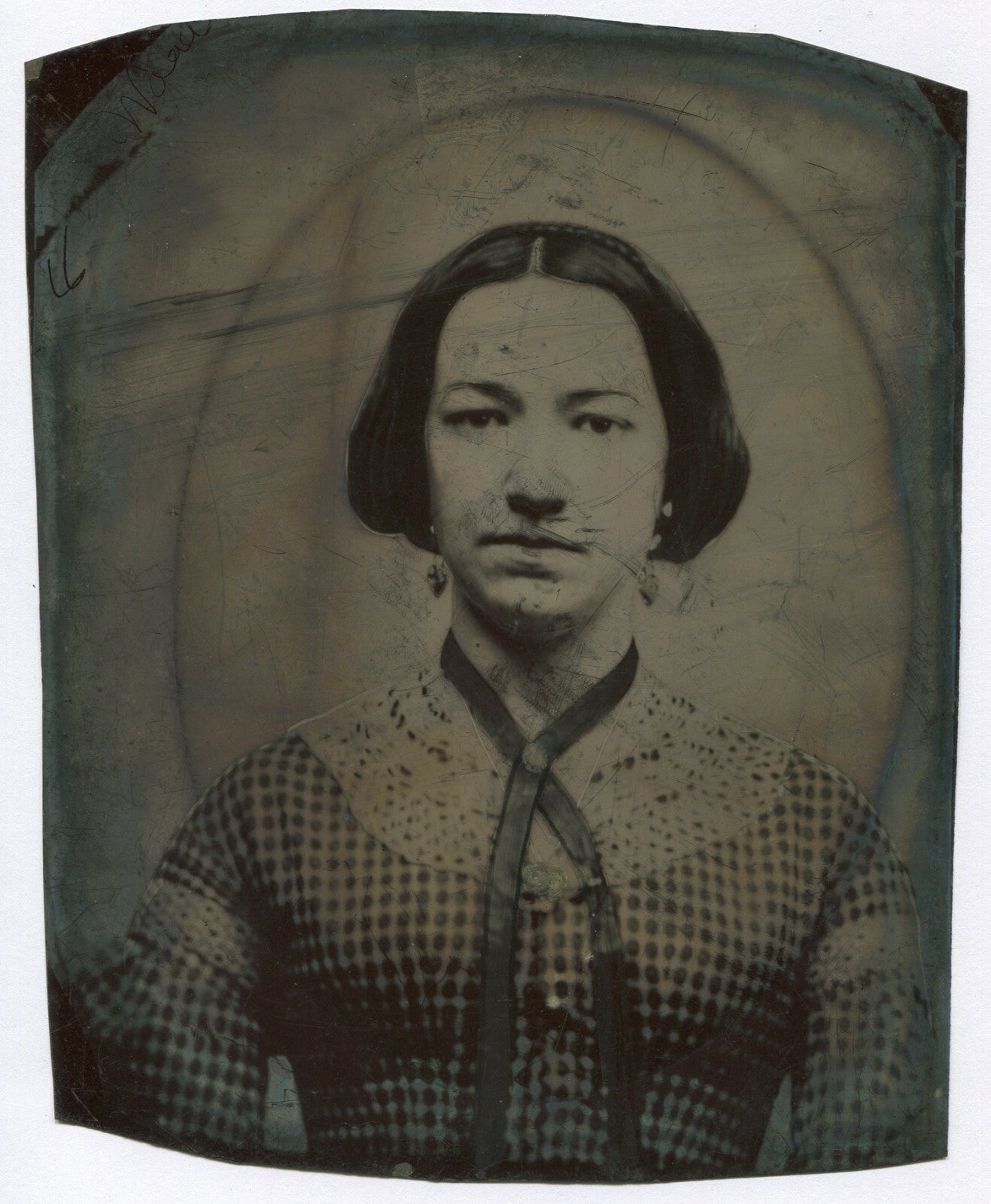 WOMAN IN CHECKERED DRESS, RIBBON NECKLACE, AND EARRINGS. TINTYPE 8.5X7 IN.
