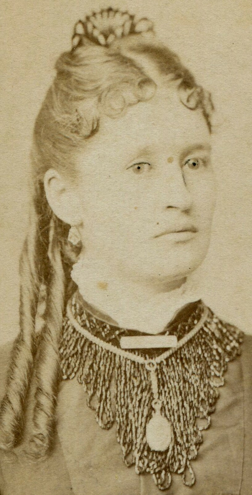 WOMAN W/FRINGE COLLAR, JEWELRY, EXTRA LONG RINGLET CURL. LANCASTER, WISCONSIN.