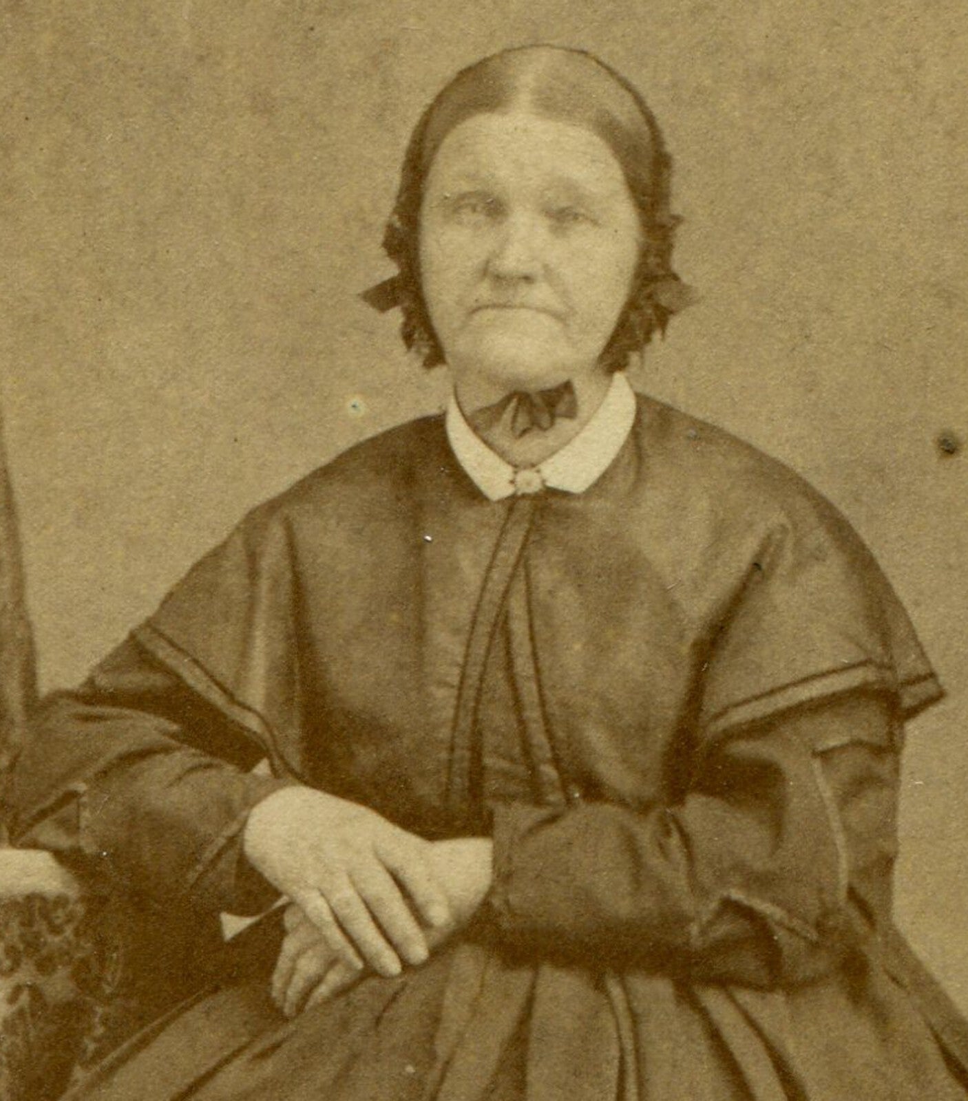 WOMAN IN BONNET, CROSSED HANDS, DEEP SET SAD EYES. CDV.