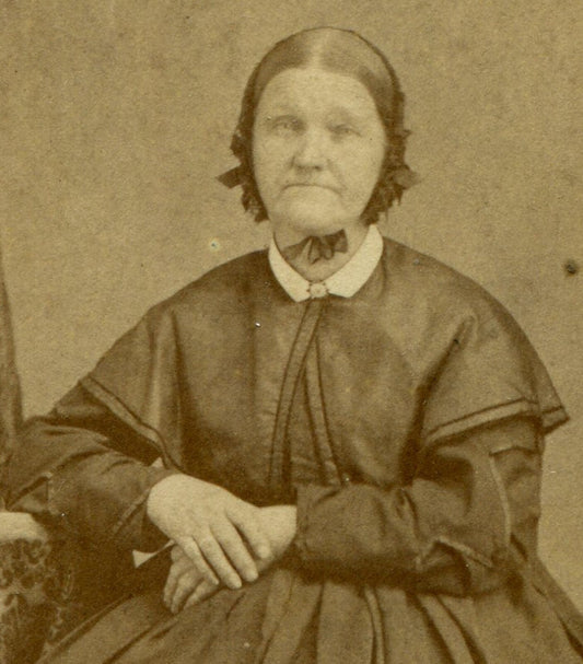 WOMAN IN BONNET, CROSSED HANDS, DEEP SET SAD EYES. CDV.