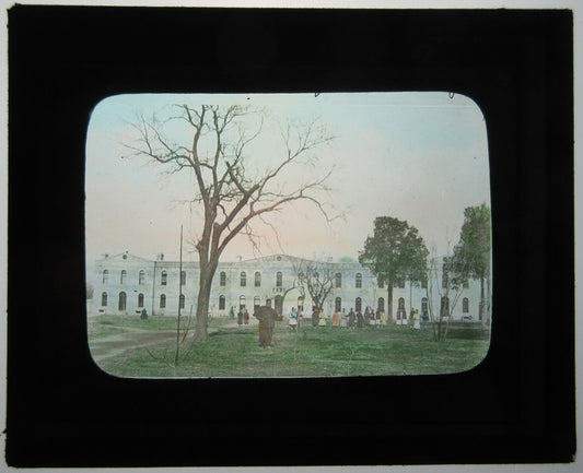 AFRICAN AMERICANS OUTSIDE LARGE BUILDING. TINTED LANTERN SLIDE.