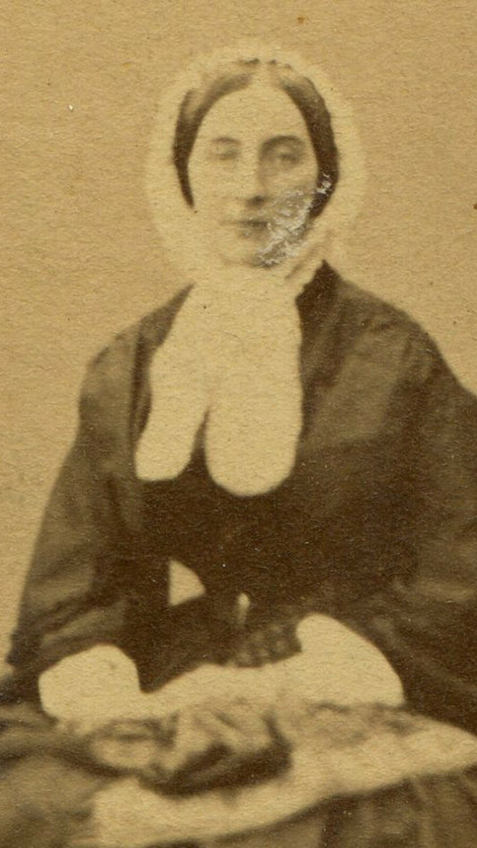 WOMAN IN BONNET WITH LONG BOW, FABRIC ON LAP. CDV.