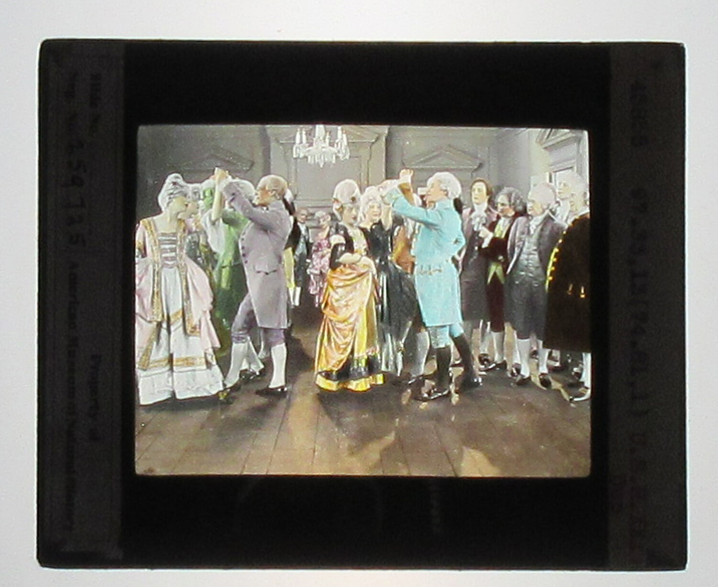 ACTORS PORTRAY COLONIAL SOCIAL GATHERING. HAND COLORED PHOTO ON GLASS.