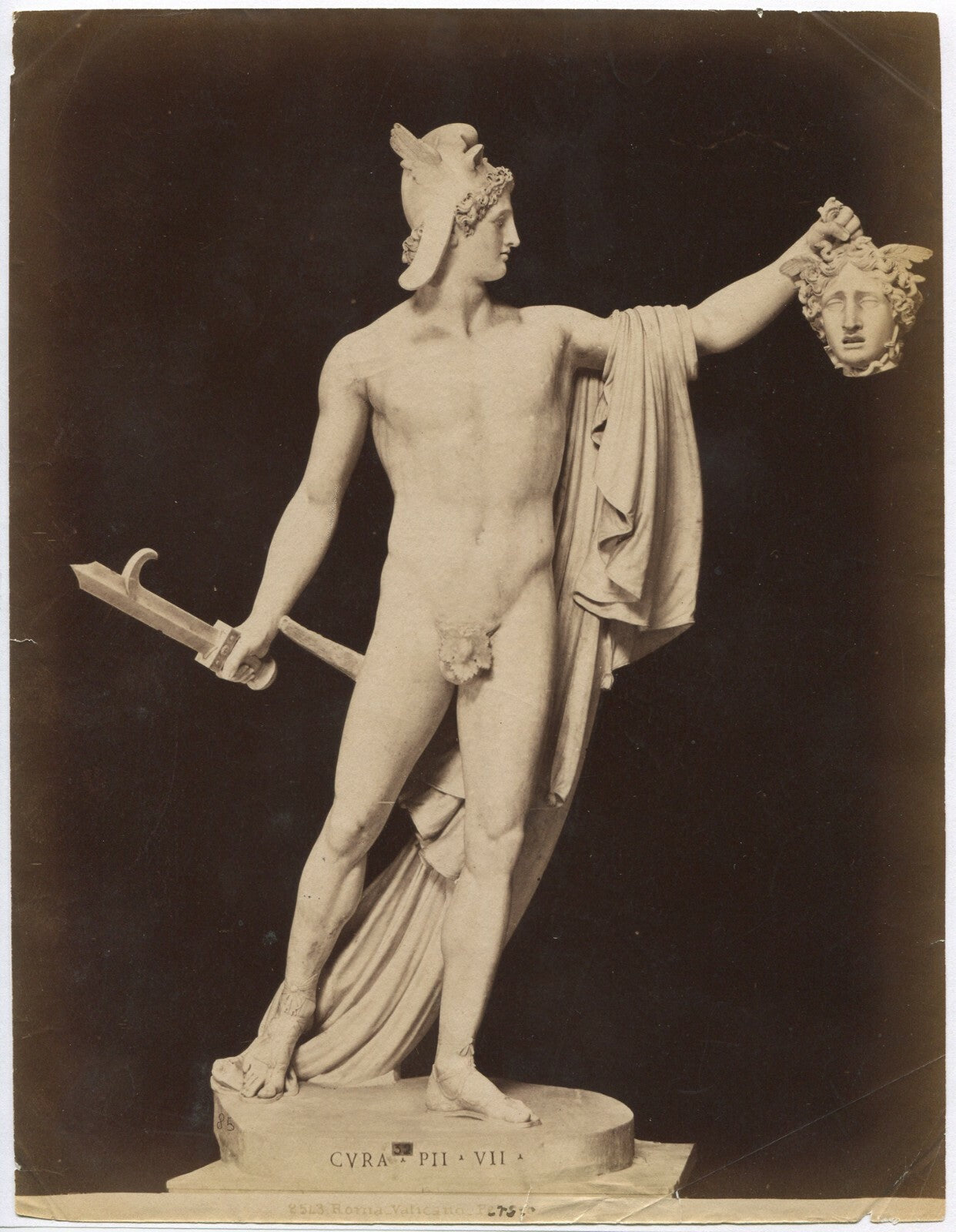 SCULPTURE OF FIGURE HOLDING DECAPITATED HEAD. YIKES. UNMOUNTED ALBUMEN.
