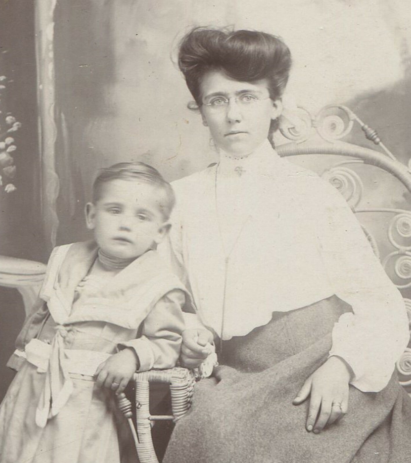 MOTHER IN GLASSES, W/CHILD. PAINTED BACKGROUND CABINET CARD.
