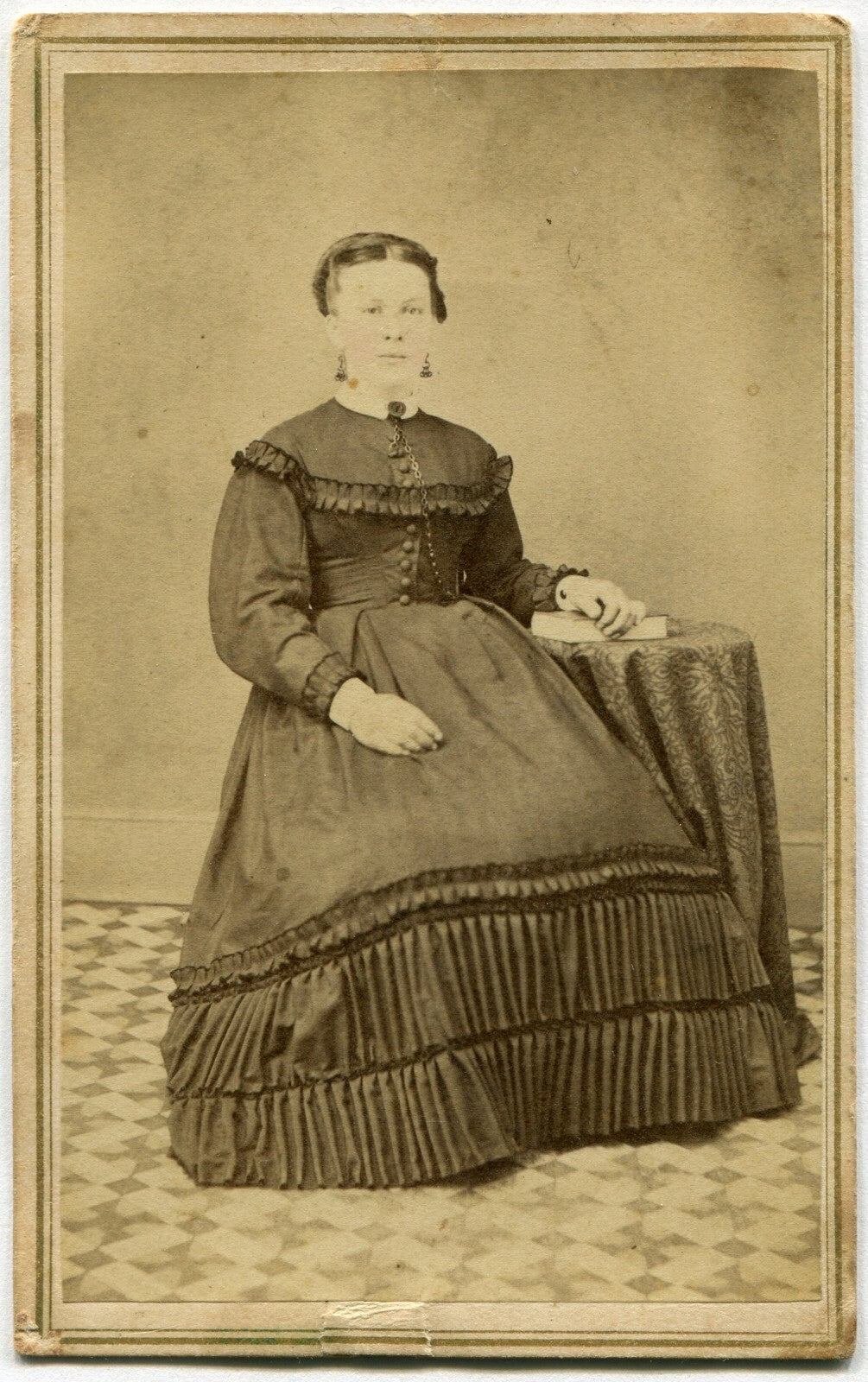 WOMAN, PLEATED DRESS SEATED AT TABLE W/BOOK. TINTED CDV. PILLOW, PA.