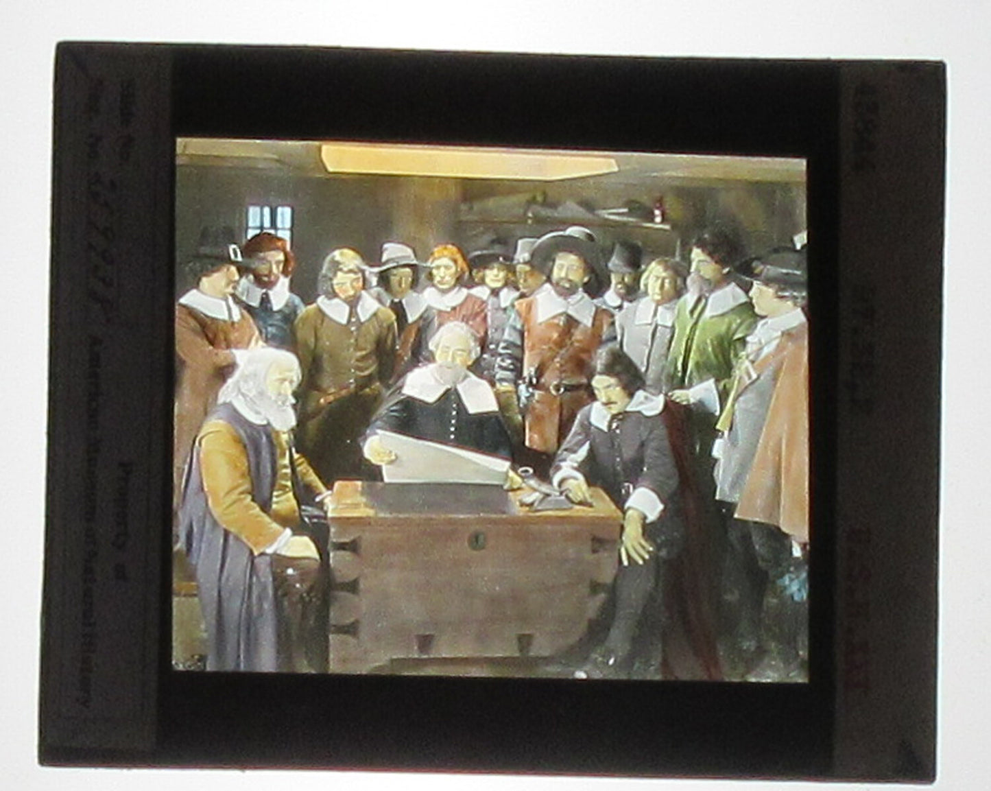 ACTORS PORTRAY MAYFLOWER PASSENGERS. HAND COLORED PHOTO ON GLASS.