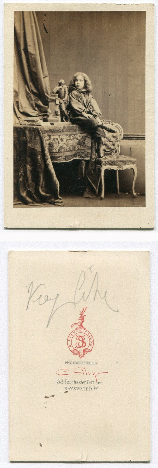 CHILD POSED WITH SMALL STATUE. WHIMSICAL STUDIO SETTING. CDV. LONDON.