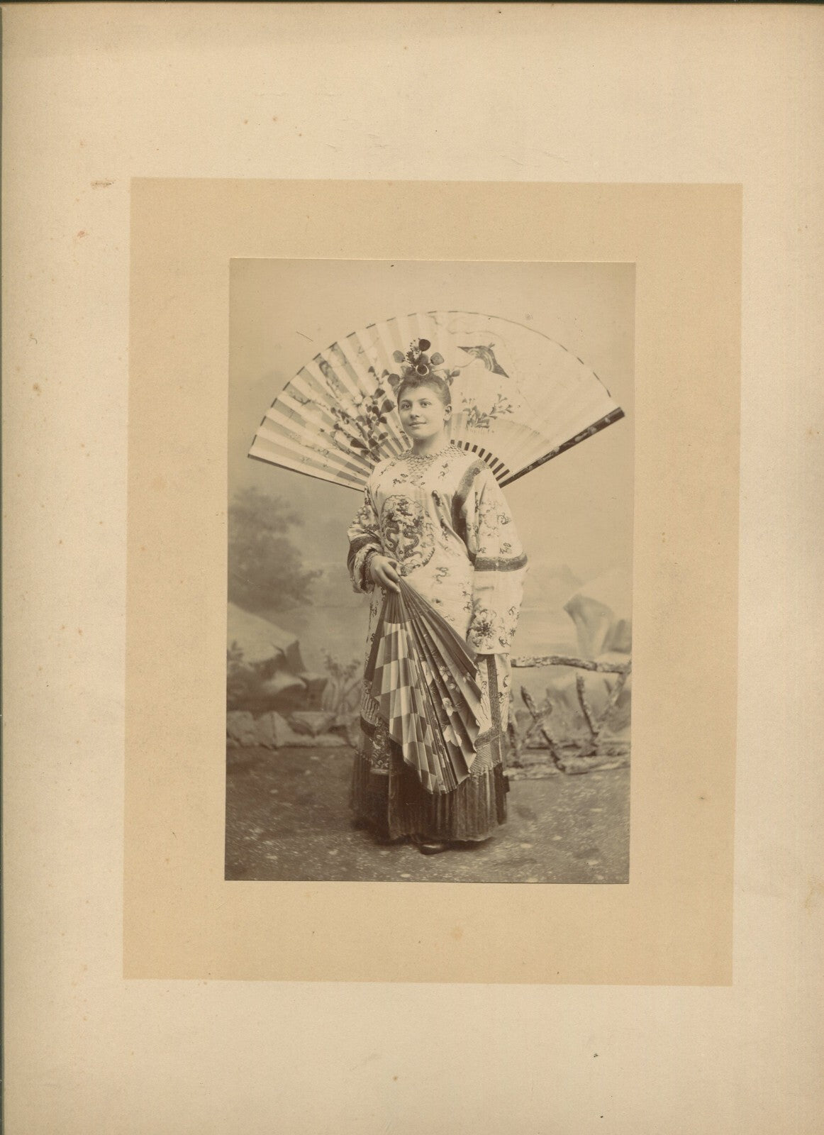 ACTRESS POSED WEARING TRADITIONAL ASIAN DRESS, LARGE FAN. 6.5X4.5 ALBUMAN.